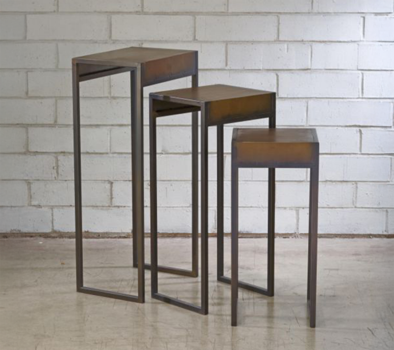 Burnished Gold Metal Side Tables are arranged in a morden rustic showroom setting.