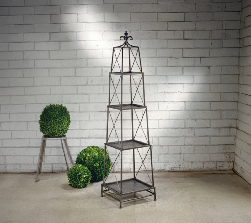 This Gunmetal Gray 4-Tier Metal Obelisk Display is arranged in a morden rustic showroom setting.