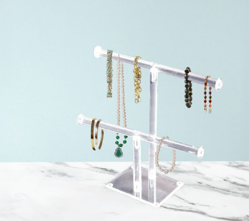 Acrylic 2-Tier Necklace And Bracelet Bar Display, elegantly displaying various accessories in an aesthetic setting