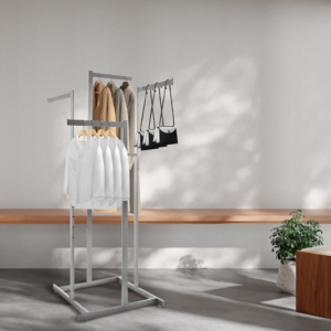 Satin chrome 4 way garment rack with 16" straight arms, elegantly displaying various clothes in an aesthetic setting