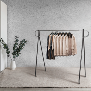 Chrome 54" single hangrail display rack with clothes modeled in an aesthetic ambiance